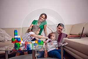 Happy loving family. children playing with blocks toys