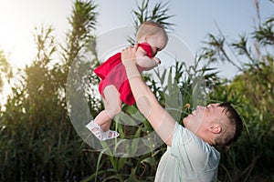 Happy loving family. Father and his daughter baby girl playing and hugging outdoors