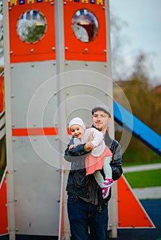 Happy loving family. Father and his daughter child girl playing and hugging outdoors. Cute little girl hugs daddy. Concept of