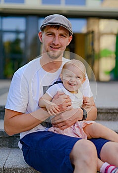 Happy loving family. Father and his daughter child girl playing and hugging outdoors. Cute little girl hugs daddy. Concept of