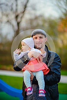 Happy loving family. Father and his daughter child girl playing and hugging outdoors. Cute little girl hugs daddy. Concept of