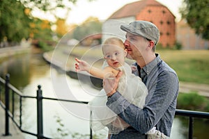 Happy loving family. Father and his daughter child girl playing and hugging outdoors. Cute little girl hugs daddy. Concept of