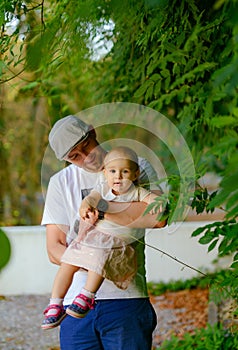 Happy loving family. Father and his daughter child girl playing and hugging outdoors. Cute little girl hugs daddy. Concept of