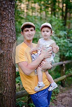 Happy loving family. Father and his daughter child girl playing and hugging outdoors. Cute little girl hugs daddy. Concept of