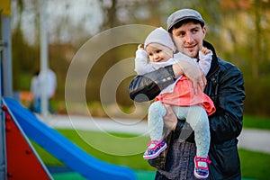 Happy loving family. Father and his daughter child girl playing and hugging outdoors. Cute little girl hugs daddy. Concept of