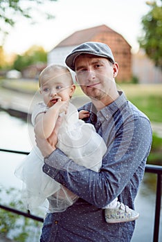 Happy loving family. Father and his daughter child girl playing and hugging outdoors. Cute little girl hugs daddy. Concept of