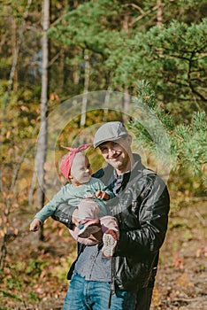 Happy loving family. Father and his daughter child girl playing and hugging outdoors. Cute little girl hugs daddy. Concept of