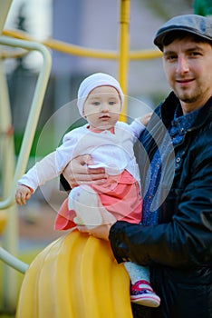 Happy loving family. Father and his daughter child girl playing and hugging outdoors. Cute little girl hugs daddy. Concept of