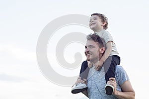 Happy loving family. Father and his son baby boy playing and hugging outdoors.