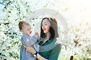 Happy loving family mom and child girl kissing and hugging outdoor in blossom park. Mother day, Relationship Love Values