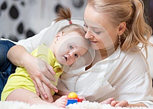 Happy loving family. Mom and her daughter baby playing and hugging.