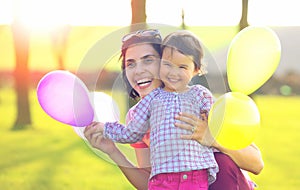 Happy loving family. mother and child girl playing outside