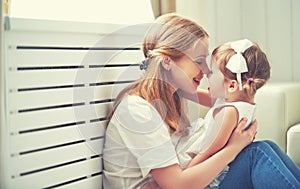 Happy loving family. mother and child playing, kissing and hugg