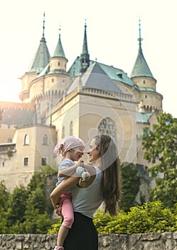 Kiss each other on the background of a beautiful castle