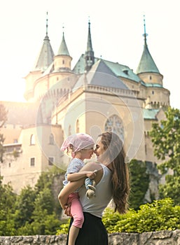 Kiss each other on the background of a beautiful castle