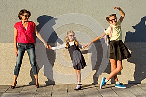 A happy loving family - mother and daughter of a schoolgirl, hol