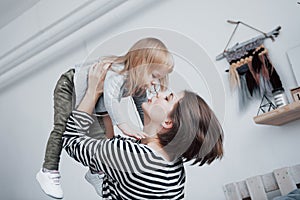 Happy loving family. Mother and her daughter child girl playing and hugging