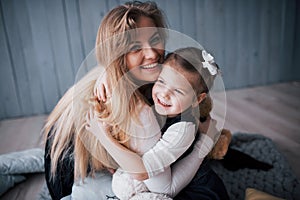 Happy loving family. Mother and her daughter child girl playing and hugging