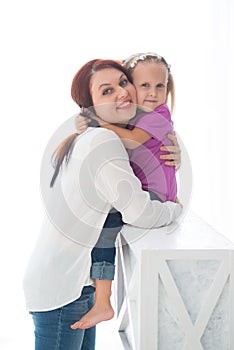 Happy loving family. Mother and her daughter child girl playing and hugging