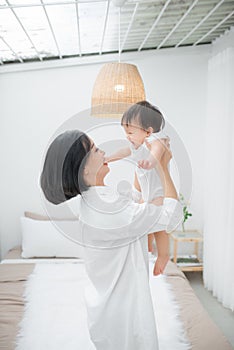 Happy loving family. Mother and her daughter child girl playing and hugging