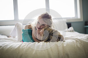 Happy loving family. Mother and her daughter child girl playing and hugging.on bed