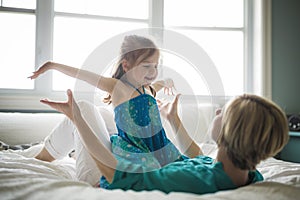 Happy loving family. Mother and her daughter child girl playing and hugging.on bed