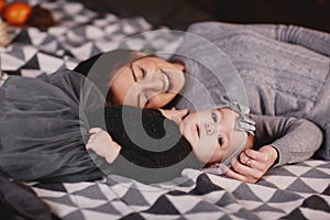 Happy loving family. Mother and her daughter child girl playing and hugging. happy mother hugging daughter in bed