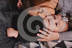 Happy loving family. Mother and her daughter child girl playing and hugging. happy mother kisses daughter in bed