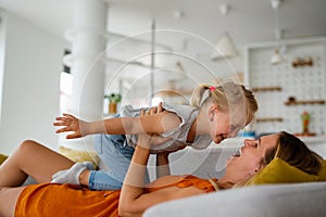 Happy loving family. Mother and her daughter child girl playing and hugging together at home