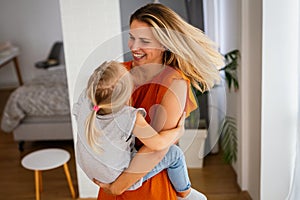 Happy loving family. Mother and her daughter child girl playing and hugging together at home