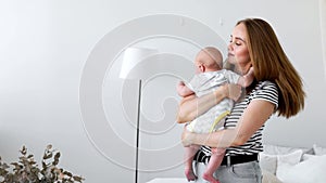 Happy loving family. mother playing with her baby in the bedroom