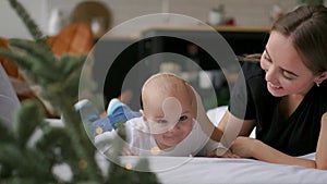 Happy loving family. mother playing with her baby in the bedroom.