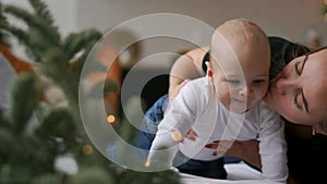 Happy loving family. mother playing with her baby in the bedroom.