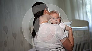 Happy loving family. Mother playing with her baby in the bedroom.