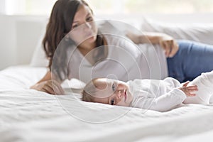 Happy loving family. mother playing with her baby in the bedroom.