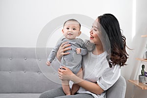 Happy loving family. mother playing with her baby in the living room