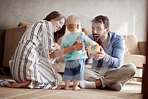 Happy loving family. parents playing with her baby at home