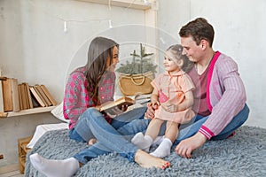 Happy loving family. pretty young mother reading a book to her daughter