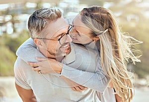 Happy and loving mature caucasian couple enjoying a romantic date at the beach together on a sunny day. Cheerful