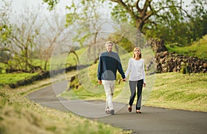 Happy loving middle aged couple walking