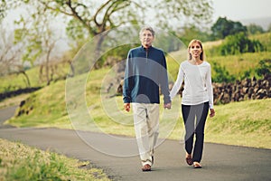 Happy loving middle aged couple walking