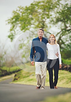 Happy loving middle aged couple walking