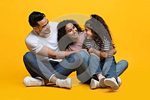 Happy Loving Middle Eastern Family Of Three Having Fun Together In Studio