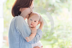 happy loving mother and her baby outdoors