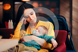 Happy Loving Mother Holding Sleeping Baby in her Arms