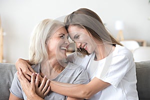 Happy loving older mother and grown millennial daughter laughing