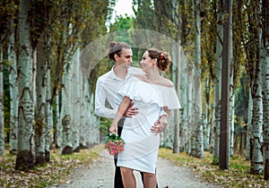 Happy loving wedding couple in the autumn park