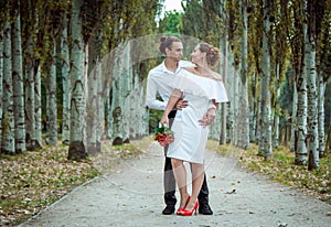 Happy loving wedding couple in the autumn park.