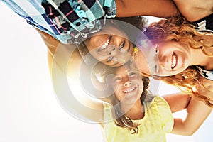 Happy, low angle and portrait of children in summer for friendship, playing and fun together. Diversity, youth and girls