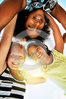 Happy, low angle and portrait of kids in summer for friendship, playing and fun together. Diversity, youth and girls